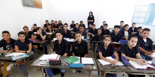 Teacher Manel el Ayachi poses for a picture on the first day of a new school year at Linine Street Preparatory School in Tunis, Tunisia, September 16, 2015. Schools have reopened, with around 2 million pupils heading back to classrooms after a three-month summer break. Nearly three years after Taliban gunmen shot Pakistani schoolgirl Malala Yousafzai, the teenage activist last week urged world leaders gathered in New York to help millions more children go to school. World Teachers' Day falls on 5 October, a Unesco initiative highlighting the work of educators struggling to teach children amid intimidation in Pakistan, conflict in Syria or poverty in Vietnam. Even so, there have been some improvements: the number of children not attending primary school has plummeted to an estimated 57 million worldwide in 2015, the U.N. says, down from 100 million 15 years ago. Reuters photographers have documented learning around the world, from well-resourced schools to pupils crammed into corridors in the Philippines, on boats in Brazil or in crowded classrooms in Burundi. REUTERS/Anis MiliPICTURE 28 OF 47 FOR WIDER IMAGE STORY "SCHOOLS AROUND THE WORLD"SEARCH "EDUCATORS SCHOOLS" FOR ALL IMAGES