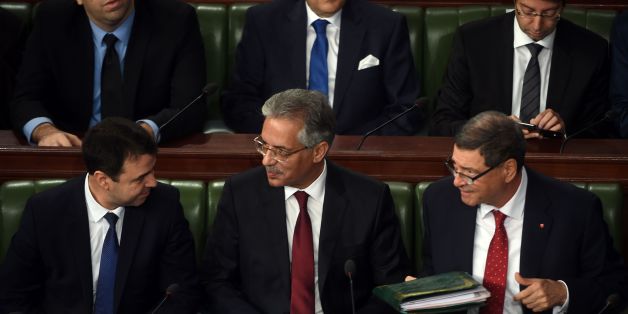 Tunisian Prime Minister Habib Essid (R) talks with newly-appointed Justice Minister Amor Mansour (C) and Interior Minister Hedi Majdoub on January 11, 2016 during a session at the assembly of the representatives of the people (ARP) in Tunis before a confidence vote to approve the new government.
Essid announced a major cabinet reshuffle on January 6, 2016 as his government grapples with a growing jihadist threat and a feeble economy.
/ AFP / FETHI BELAID (Photo credit should read FETHI BELAID/AFP/Getty Images)