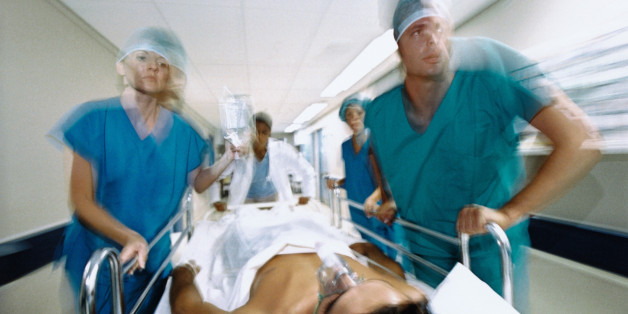 Hospital workers rushing with patient on gurney