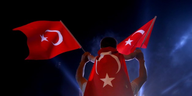ISTANBUL, TURKEY - AUGUST 1: A boy waves a Turkish flag with his father as people gather to protest against July 15 failed military coup attempt at Taksim Square in Istanbul, Turkey on August 1, 2016. Turkish officials accuse U.S.-based Turkish citizen Fetullah Gulen plotting to overthrow the government of President Erdogan as the culmination of a long running campaign to infiltrate Turkish institutions including the military, the police and the judiciary. (Photo by Abdullah Coskun/Anadolu Agen