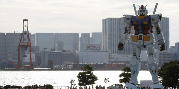 Visitors look at an 18-meter tall "Gundam" character from a popular Japanese television animation series, at a park in Tokyo July 7, 2009. The full-scale model of the television animation character was built to celebrate the 30th anniversary of the start of its broadcasting. REUTERS/Kim Kyung-Hoon (JAPAN ANNIVERSARY ENTERTAINMENT SOCIETY SCI TECH MEDIA IMAGES OF THE DAY)