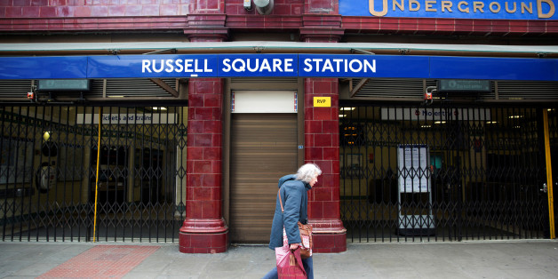 FILE PHOTO - A woman walks past a closed entrance of Russell Square underground station in London April 29, 2014. REUTERS/Neil Hall/File Photo