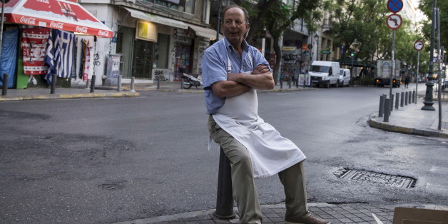 A street vendor waits for customers during early morning in Athens, Greece, July 4, 2015. If a 'No' in Sunday's referendum eventually takes Greece out of Europe's single currency, any "new drachma" or temporary payment unit could be worth as little as a fifth of the euro now in circulation. REUTERS/Marko Djurica