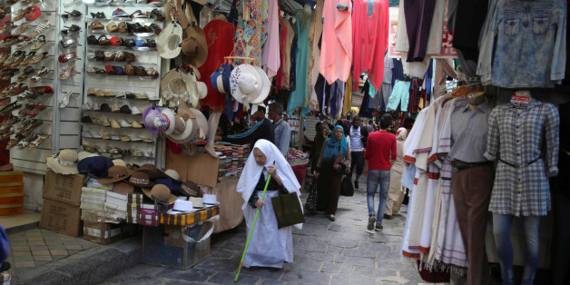 People walk past a clothes shop in Tunis, Tunisia, April 25, 2016. REUTERS/Zoubeir Souissi