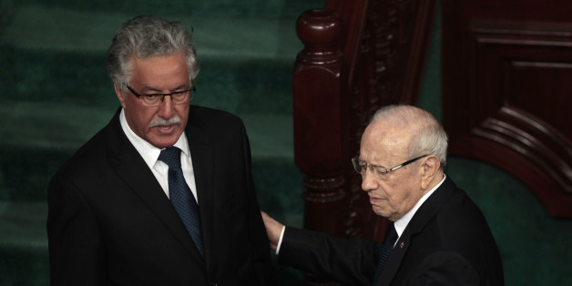 Beji Caid Essebsi (R), leader of Tunisia's secular Nidaa Tounes party and a presidential candidate, speaks with Hamma Hammami , leader of Tunisia's Popular Front Party, in the assembly building in Tunis December 2, 2014. Tunisia's first full elected parliament held its opening session on Tuesday with a challenge to implement the democracy its people sought when they marched in the 2011 revolt against autocrat Zine el-Abidine Ben Ali.REUTERS/Zoubeir Souissi (TUNISIA - Tags: POLITICS ELECTIONS)