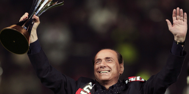 The AC Milan President Silvio Berlusconi lifts the FIFA Club World Cup 2007 trophy before their Italian Serie A match against Napoli at the San Siro Stadium in Milan, January 13, 2008. AC Milan won the title against Argentine club Boca Juniors in Yokohama, south of Tokyo December 16, 2007. REUTERS/Daniele La Monaca (ITALY)