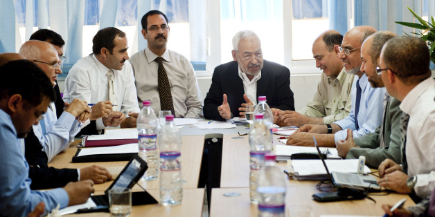 Tunisian leader and founder of the moderate islamist party Ennahda, Rached Ghannouchi, center right, gestures as he chairs an executive board at the party's headquarters in Tunis, Thursday, Oct. 27, 2011. Authorities say the latest results from Tunisia's landmark elections indicate the moderate Islamist party is holding onto its lead, taking at least 44 percent of seats counted so far for an assembly tasked with writing a new constitution. (AP Photo/Benjamin Girette)