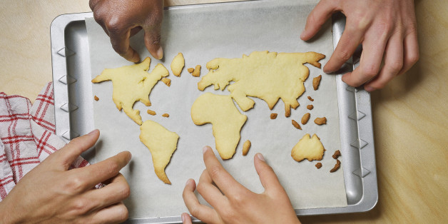 Hands reaching for world map cookies