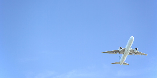 Commercial Airplane Flying Against A Blue Sky