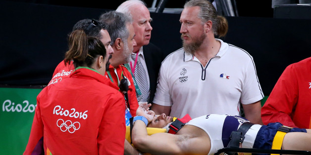 RIO DE JANEIRO, BRAZIL - AUGUST 06: Samir Ait Said of France receives medical attention after breaking his leg while competing on the vault during the Artistic Gymnastics Men's Team qualification on Day 1 of the Rio 2016 Olympic Games at Rio Olympic Arena on August 6, 2016 in Rio de Janeiro, Brazil. (Photo by Alex Livesey/Getty Images)