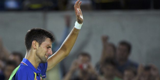 2016 Rio Olympics - Tennis - Preliminary - Men's Singles First Round - Olympic Tennis Centre - Rio de Janeiro, Brazil - 07/08/2016. Novak Djokovic (SRB) of Serbia reacts after losing his match against Juan Martin Del Potro (ARG) of Argentina. REUTERS/Toby Melville TPX IMAGES OF THE DAY. FOR EDITORIAL USE ONLY. NOT FOR SALE FOR MARKETING OR ADVERTISING CAMPAIGNS.