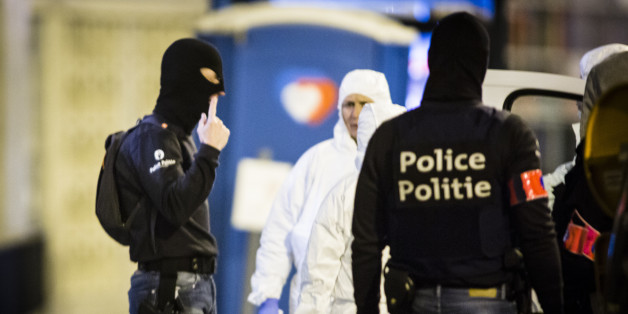 Molenbeek, Brussels, Belgium, 18 March 2016. Forensic researchers in white suits do scientific research at the house where Salam Abdeslam was shot and captured earlier this day. forensic experts talk with police on the scene. A hartshaped logo in the background on a temporary toilet (Photo by Sander de Wilde/Corbis via Getty Images)