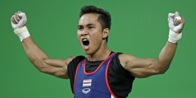 Sinphet Kruaithong, of Thailand, celebrates a successful lift in the men's 56kg weightlifting competition at the 2016 Summer Olympics in Rio de Janeiro, Brazil, Sunday, Aug. 7, 2016. Kruaithong won the bronze medal. (AP Photo/Mike Groll)