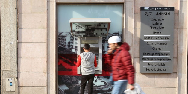 A man uses a cash machine in downtown Tunis, Tunisia, March 14, 2016. REUTERS/Zoubeir Souissi