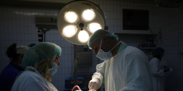 In this photo taken Friday, Jan. 15, 2010, Dr. Abbas al-Sahan, right, performs rhinoplasty surgery on Sarah Saad Abdul-Hameed in Baghdad, Iraq. For years, the only role for plastic surgeons in Iraq has been to reconstruct the torn victims of bombings, mortars and suicide attackers. It may be a sign of change, then, that a new type of patient is now turning up in their clinics _ seeking nose jobs, Botox and liposuction. (AP Photo/ Hadi Mizban)