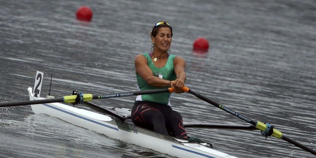 2016 Rio Olympics - Rowing - Repechage - Women's Single Sculls Repechages - Lagoa Stadium - Rio De Janeiro, Brazil - 08/08/2016. Amina Rouba (ALG) of Algeria wins the women's single sculls repechages. REUTERS/Carlos Barria FOR EDITORIAL USE ONLY. NOT FOR SALE FOR MARKETING OR ADVERTISING CAMPAIGNS.