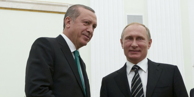 Russian President Vladimir Putin shakes hands with Turkey's President Recep Tayyip Erdogan, left, in Moscow's Kremlin, Russia, Wednesday, Sept. 23, 2015. Putin was joined at Wednesday's ceremonial opening of the Russian capital's new main mosque, by Erdogan and Palestinian President Mahmoud Abbas. (AP Photo/Ivan Sekretarev, Pool)