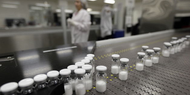 In this Monday, May 18, 2015, photo, vials of the drug Kogenate FS, a medicine used to replace the clotting factor missing in people with hemophilia, move along an automated packaging line at Bayer Corporation labs in Berkeley, Calif. Bayer is increasing everything from marketing and research operations in the U.S. to the number of its nonprescription medicines in pharmacies and grocery stores. (AP Photo/Ben Margot)