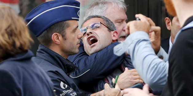 An opponent to the Turkish government is arrested as Turkey's President Tayyip Erdogan and First Lady Emine arrive at the opening of the exhibition Europalia Turkey in Brussels, Belgium October 6, 2015. Turkey's President Tayyip Erdogan and First Lady Emine are on a two-day state visit to Belgium. REUTERS/Francois Lenoir