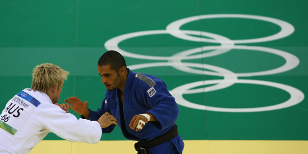 BEIJING - AUGUST 10: Mounir Benamadi (R) of Algeria competes with Steven Brown of Australia in the Men's -66 kg Preliminary contest during day 2 of the Beijing 2008 Olympic Games at the University of Science and Technology Beijing Gymnasium on August 10, 2008 in Beijing, China. (Photo by Clive Rose/Getty Images)