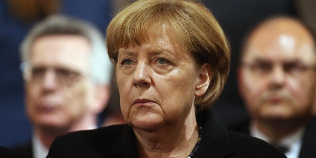 MUNICH, GERMANY - JULY 31: German chancellor Angela Merkel (C) attends a memorial service for the victims of last week's shooting spree that left nine victims dead on July 31, 2016 in Munich, Germany. David Ali Sonboly, an 18-year-old German of Iranian descent, killed nine people in a shooting spree near and in a shopping center before killing himself in a park. Investigators have found evidence Sonboly found inspiration in the 2011 mass shooting in Norway by Anders Breivik. (Photo by Johannes Simon/Getty Images)