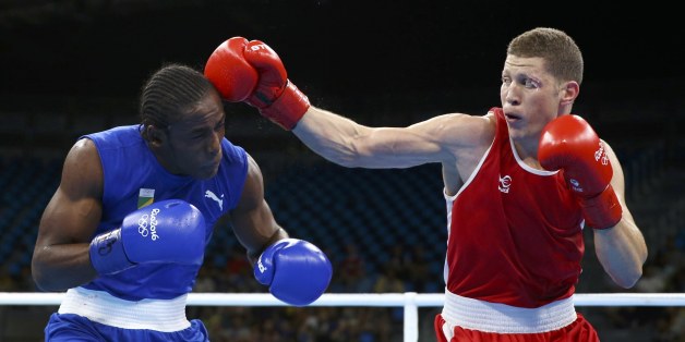 2016 Rio Olympics - Boxing - Preliminary - Men's Middle (75kg) Round of 32 Bout 67 - Riocentro - Pavilion 6 - Rio de Janeiro, Brazil - 09/08/2016. Ilyas Abbadi (ALG) of Algeria and Mpi Anauel Ngamissengue (CGO) of Congo compete. REUTERS/Peter Cziborra FOR EDITORIAL USE ONLY. NOT FOR SALE FOR MARKETING OR ADVERTISING CAMPAIGNS.