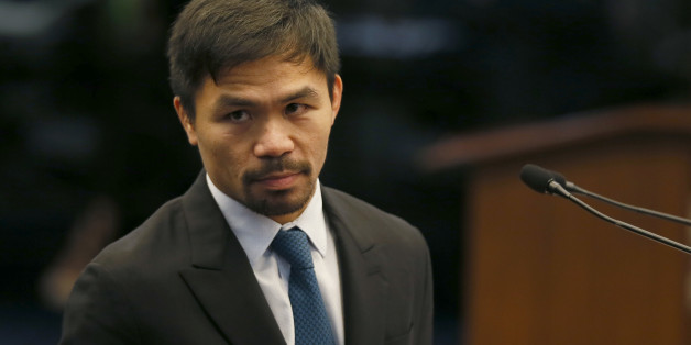 Filipino boxer and now Senator Manny Pacquiao listens to an interpellation by a fellow senator shortly after delivering his "privileged speech" at the session of the Philippine Senate Monday, Aug. 8, 2016, in suburban Pasay city south of Manila, Philippines. Pacquiao urged Congress to pass a law to restore capital punishment in the wake of the "War on Drugs" campaign by Philippine President Rodrigo Duterte.(AP Photo/Bullit Marquez)