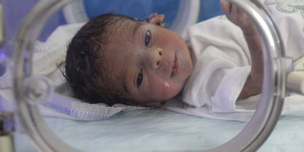 A new born baby is seen in an intensive care unit at a maternity hospital in Baghdad, Iraq, Sunday, Oct. 30, 2011. According to Iraq's Health Ministry, Iraq witnesses the birth of more than one million children a year. As of Oct. 31, according to the U.N. Population Fund, there will be 7 billion people sharing Earth's land and resources. (AP Photo/Karim Kadim)
