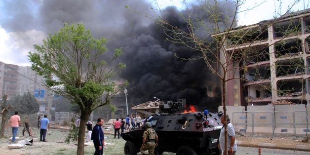 Peoplz stand near the Midyat Police station as people Smokes rises from it after an explosion on June 8, 2016 in Midyat, southeast Turkey .
Three people were killed and dozens injured in a car bombing on June 8, 2016 at a police station in southeast Turkey, a day before 11 people were killed in an attack on police in Istanbul / AFP / STR (Photo credit should read STR/AFP/Getty Images)