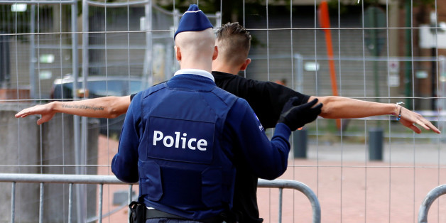 A Belgian police officer searches a visitor outside the main police station where a machete-wielding assailant attacked and injured two female police officers on Saturday in Charleroi, August 9, 2016. REUTERS/Francois Lenoir