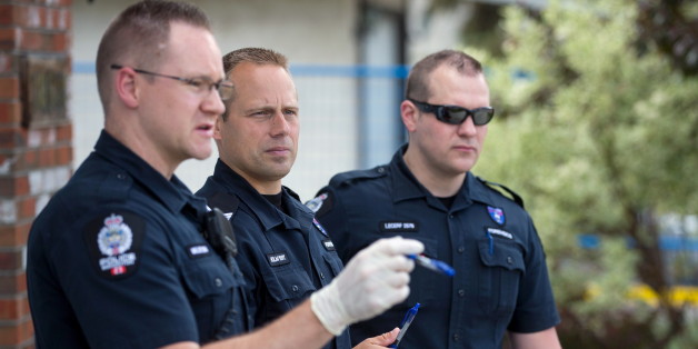Investigators inspect the scene where a police officer was shot and killed on Monday, in Edmonton, June 9, 2015. Constable Daniel Woodall was killed and another officer Sergeant Jason Harley injured on Monday in Edmonton, Canada, after an exchange of fire with Norman Raddatz, police said. The officers were attempting to arrest Raddatz on Monday evening, when the shootings happened, police said. REUTERS/Topher Seguin