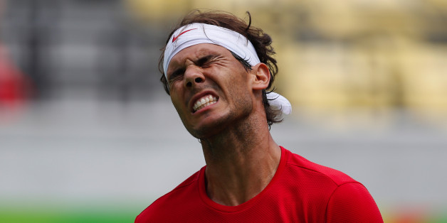 Spain's Rafael Nadal grimaces after losing a point to France's Gilles Simon during the men's tennis competition at the 2016 Summer Olympics in Rio de Janeiro, Brazil, Thursday, Aug. 11, 2016. (AP Photo/Vadim Ghirda)