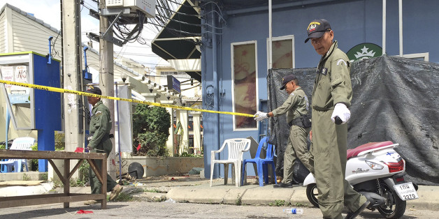 Investigators work at the scene of an explosion in the resort town of Hua Hin, 240 kilometers (150 miles) south of Bangkok, Thailand Friday, Aug. 12, 2016. The blast followed a series of two explosions in Hua Hin Thursday evening that left one person dead and a number injured. (AP Photo/Jerry Harmer)