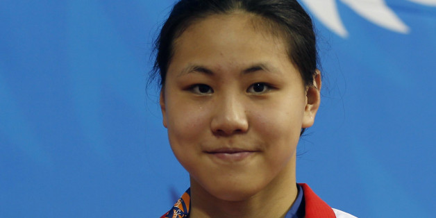 Chen Xinyi posiert 2014 mit einer Goldmedaille.