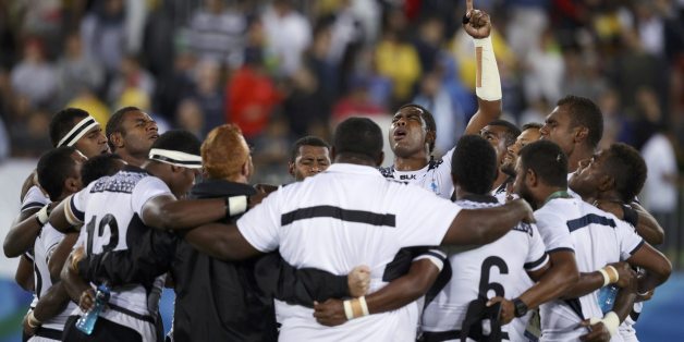 2016 Rio Olympics - Rugby - Men's Gold Medal Match - Fiji v Great Britain - Deodoro Stadium - Rio de Janeiro, Brazil - 11/08/2016. Fiji players celebrate at the end of their match. REUTERS/Phil Noble (BRAZIL - Tags: SPORT OLYMPICS SPORT RUGBY TPX IMAGES OF THE DAY) FOR EDITORIAL USE ONLY. NOT FOR SALE FOR MARKETING OR ADVERTISING CAMPAIGNS.