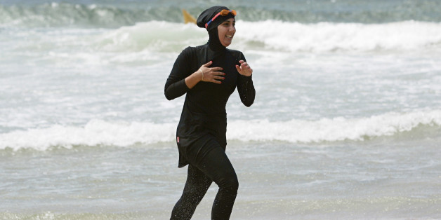 Twenty-year-old trainee volunteer surf life saver Mecca Laalaa runs along North Cronulla Beach in Sydney during her Bronze medallion competency test January 13, 2007. Specifically designed for Muslim women, Laalaa's body-covering swimming costume has been named the "burkini" by its Sydney based designer Aheda Zanetti. REUTERS/Tim Wimborne (AUSTRALIA)