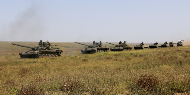 A column of Ukrainian tanks and APCs move towards the de-facto border with Crimea near Kherson, southern Ukraine, Friday, Aug. 12, 2016. Ukraine put its troops on combat alert Thursday along the country's de-facto borders with Crimea and separatist rebels in the east amid an escalating war of words with Russia over Crimea. (AP Photo/Aleksandr Shulman)