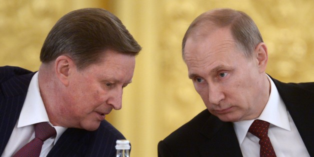 Kremlin's Chief of Staff Sergei Ivanov, left, speaks to Russian President Vladimir Putin during a Council of Physical Fitness and Sports in the Kremlin in Moscow, Russia, Monday, March 24, 2014. (AP Photo/RIA-Novosti, Alexei Nikolsky, Presidential Press Service)