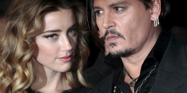 Cast member Johnny Depp and his actress wife Amber Heard arrive for the British premiere of the film "Black Mass" in London, Britain October 11, 2015. REUTERS/Suzanne Plunkett