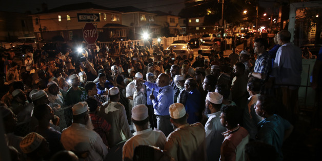 Community members pray outside the Al-Furqan Jame Mosque in Ozone Park after imam Maulama Akonjee and friend Thara Uddin were killed in the Queens borough of New York City, August 13, 2016.
