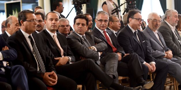 Leaders of Tunisia's politics parties including leader of the Islamist Ennahdha party Rached Ghannouchi (2R), Nidaa Tounes party general secretary Hafedh Caid Essebsi (3R), former secretary-general of anti-Islamist Nidaa Tounes party Mohsen Marzouk(C), leader of the Free Patriotic Union (UPL) Slim Riahi (3L) and Afek Touis party president Yacine Ibrahim (2L) attend a ceremony for the signing of documents outlining the roadmap for the formation of a national unity government in Tunisia at the Carthage Palace in Carthage, some 15 kilometres on the outskirts of Tunis, on July 13, 2016.
The pact summarizes the priorities of the country's future government including; combating terrorism and corruption, boosting development and youth employment, achieving administrative reform and implementing the policy of the city and local authorities. / AFP / FETHI BELAID (Photo credit should read FETHI BELAID/AFP/Getty Images)