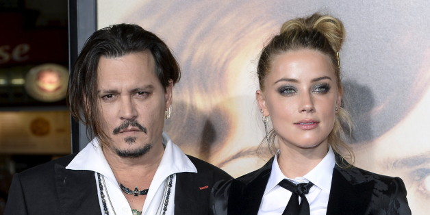 Cast member Amber Heard and husband Johnny Depp pose during the premiere of the film "The Danish Girl," in Los Angeles, California November 21, 2015. REUTERS/Kevork Djansezian/File Photo