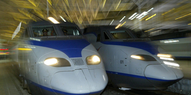 A South Korean KTX train (L) prepares to depart for Pusan city at the Seoul railway station April 1, 2004. South Korea's first high-speed railway service began before dawn on Thursday when a sleek, French-designed bullet train slipped out of Seoul bound for the southern port city of Pusan, now less than three hours away. REUTERS/Kim Kyung-Hoon KKH/GB