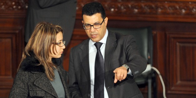 Tunisian deputy Mongi Rahoui (R) speaks with a fellow lawmaker during a meeting to debate a new constitution at the National Constituent Assembly (NCA), on January 6, 2014, in Tunis. Tunisia's national assembly approved an article in the draft constitution that would guarantee gender equality 'without discrimination' in the Muslim nation. All male and female citizens have the same rights and duties. AFP PHOTO / FETHI BELAID (Photo credit should read FETHI BELAID/AFP/Getty Images)