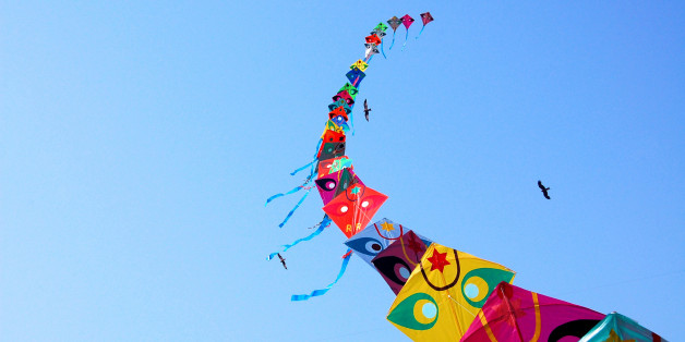 Row of kites in sky at International Kite Festival, Ahmedabad.