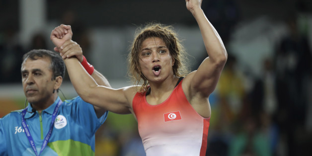 Tunisia's Marwa Amri celebrates after defeating Azerbaijan's Yuliya Ratkevich in the women's wrestling freestyle 58-kg competition bronze medal round at the 2016 Summer Olympics in Rio de Janeiro, Brazil, Wednesday, Aug. 17, 2016. (AP Photo/Markus Schreiber)