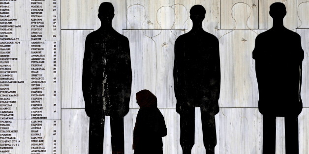 A journalist walks by a monument for 134 Greeks killed by Nazi troops in Karakolithos area in retaliation for the abduction of 17 German officers in central Greece, June 10, 2015. On April 25, 1944, during the German occupation of Greece Nazi troops executed 134 Greeks. Athens's demands for 278.7 billion Euros in reparations from Germany have gained momentum in recent years as Greeks suffer hardship during the economic crisis but while Berlin has repeatedly rejected the claims, some, including German President Joachim Gauck, have expressed their support. REUTERS/Yannis Behrakis