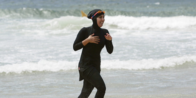 Twenty-year-old trainee volunteer surf life saver Mecca Laalaa runs along North Cronulla Beach in Sydney during her Bronze medallion competency test January 13, 2007. Specifically designed for Muslim women, Laalaa's body-covering swimming costume has been named the "burkini" by its Sydney based designer Aheda Zanetti. REUTERS/Tim Wimborne (AUSTRALIA)