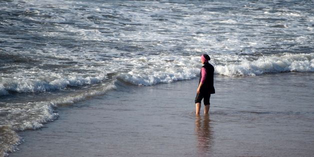 A Moroccan woman wearing a 'burkini', a full-body swimsuit designed for Muslim women, enters the sea at Oued Charrat beach, near the capital Rabat, on August 17, 2016. / AFP / FADEL SENNA (Photo credit should read FADEL SENNA/AFP/Getty Images)