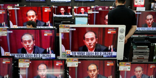 A sales assistant watches TV sets broadcasting a news report on Thae Yong Ho, North Korea's deputy ambassador in London, who has defected with his family to South Korea, in Seoul, South Korea, August 18, 2016. REUTERS/Kim Hong-Ji TPX IMAGES OF THE DAY